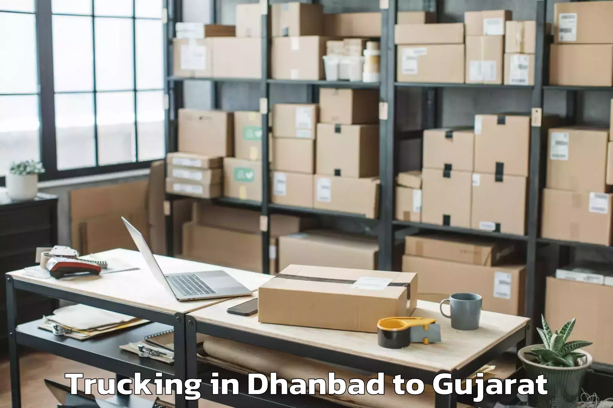 Book Dhanbad to Idar Trucking Online